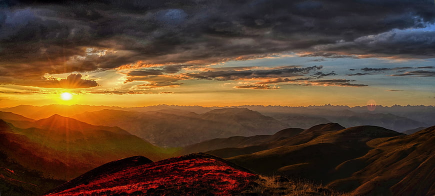 Dramatic Sunset Over Rolling Mountain Ridges