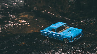 Blue Vintage Toy Car on Wet Rocks