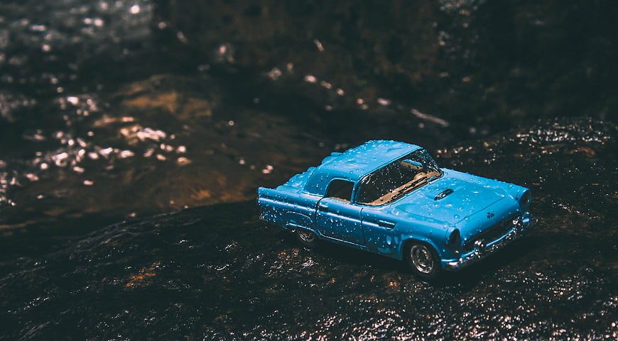 Blue Vintage Toy Car on Wet Rocks