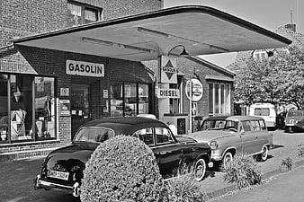 Vintage Black and White Gas Station with Classic Cars