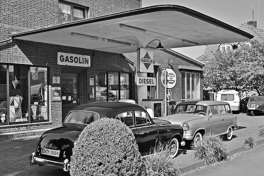 Vintage Black and White Gas Station with Classic Cars