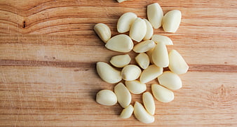 Peeled Garlic Cloves on Wooden Cutting Board