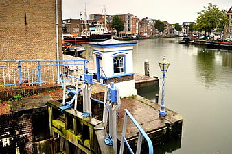 Blue and white lock gate mechanism on a canal in the Netherlands