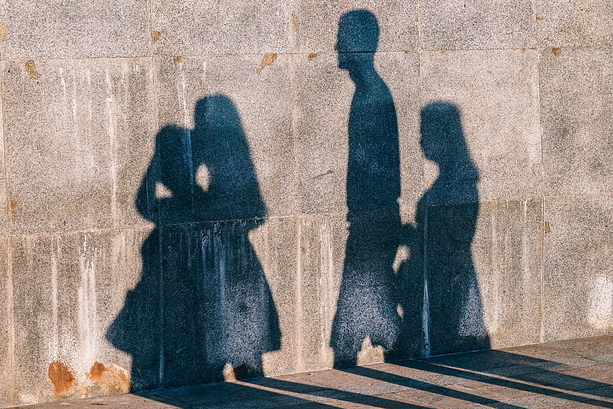 Abstract Human Silhouettes Cast On Textured Urban Concrete Wall