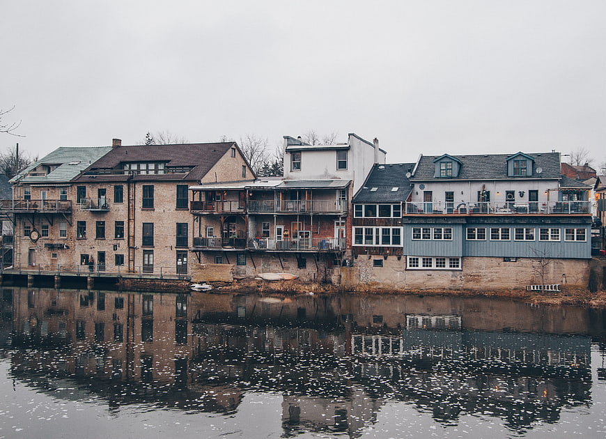 Row of waterfront houses with reflections in calm water