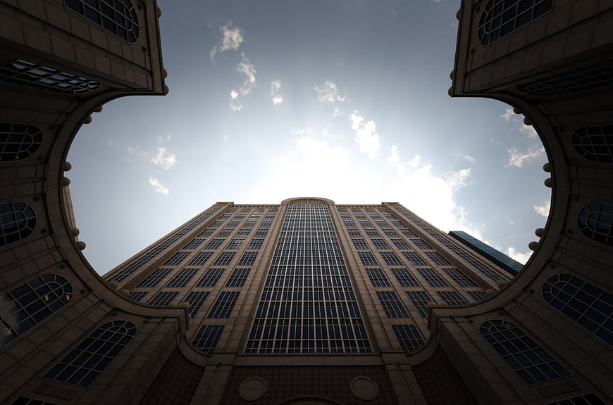 Low angle view of modern skyscraper through archway