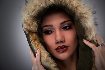 Close-up portrait of woman in fur-lined hood