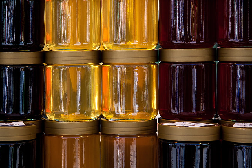 Backlit Honey Jars Displayed in a Colorful Grid