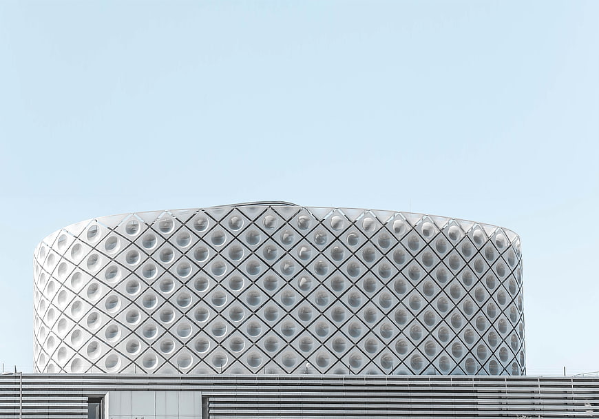 Modern White Geometric Building Facade Against Blue Sky