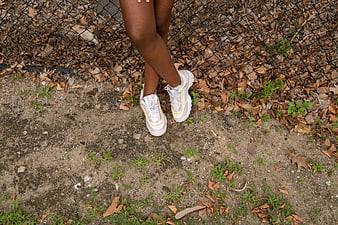 Close-up of woman's legs wearing chunky sneakers outdoors