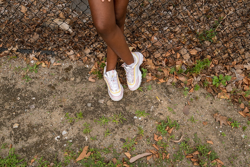 Close-up of woman's legs wearing chunky sneakers outdoors