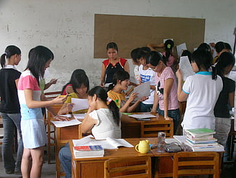 Group of female students studying and discussing in a classroom