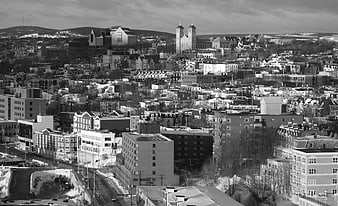 Black and white cityscape with church towers and snow