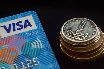 Visa Debit Card And Czech Koruna Coins On Black Background
