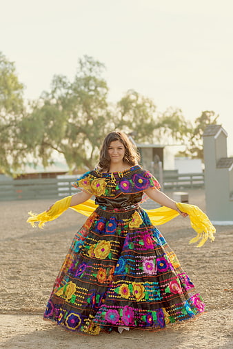 Young Woman in Colorful Traditional Mexican Dress Dancing Outdoors