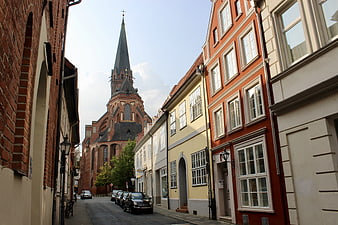 Colorful European Street with Historic Brick Church Spire