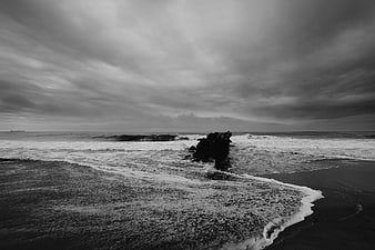 Dramatic Black and White Rocky Coastline with Stormy Sky