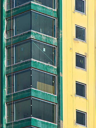 Colorful modern building facade with green and yellow walls
