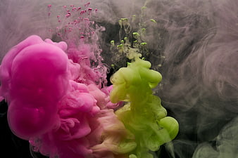 Vibrant Pink and Green Ink Diffusing in Water Abstract Background