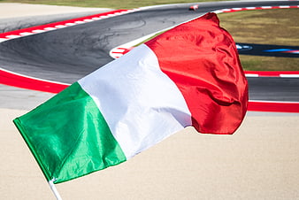 Italian flag waving at a motorsport race track