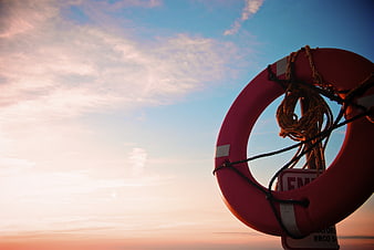 Red Lifebuoy Against Sunset Sky