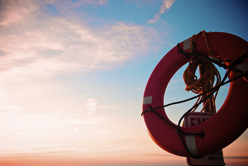 Red Lifebuoy Against Sunset Sky