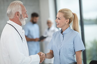 Senior Doctor and Nurse Handshake in Hospital