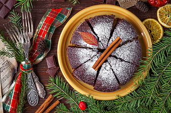 Christmas Stollen Cake With Powdered Sugar, Cinnamon, And Pine Sprigs