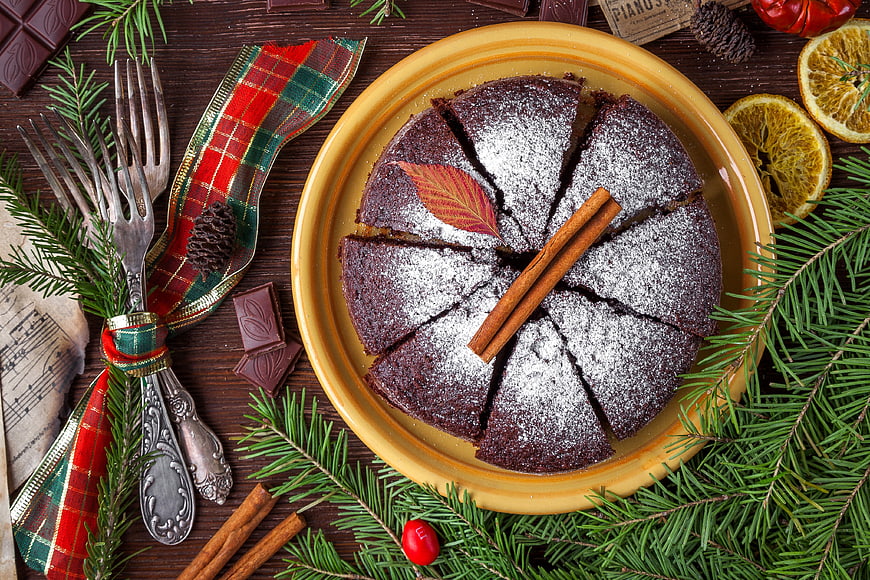 Christmas Stollen Cake With Powdered Sugar, Cinnamon, And Pine Sprigs