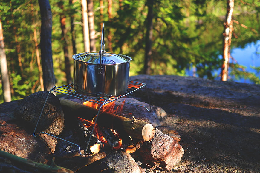 Camping Pot Cooking Over Campfire in Forest