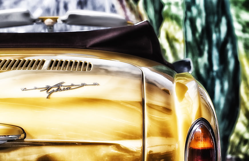 Close-up of a gold Karmann Ghia convertible rear end