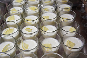 Rows of creamy lemon desserts in glass cups