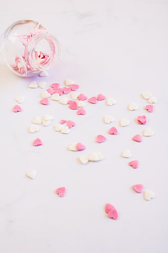 Pink and White Heart Candies Spilled from Glass Jar