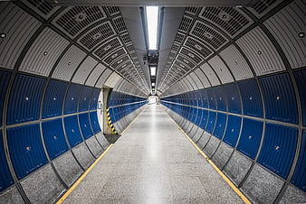 Symmetrical Blue and White Subway Tunnel Corridor