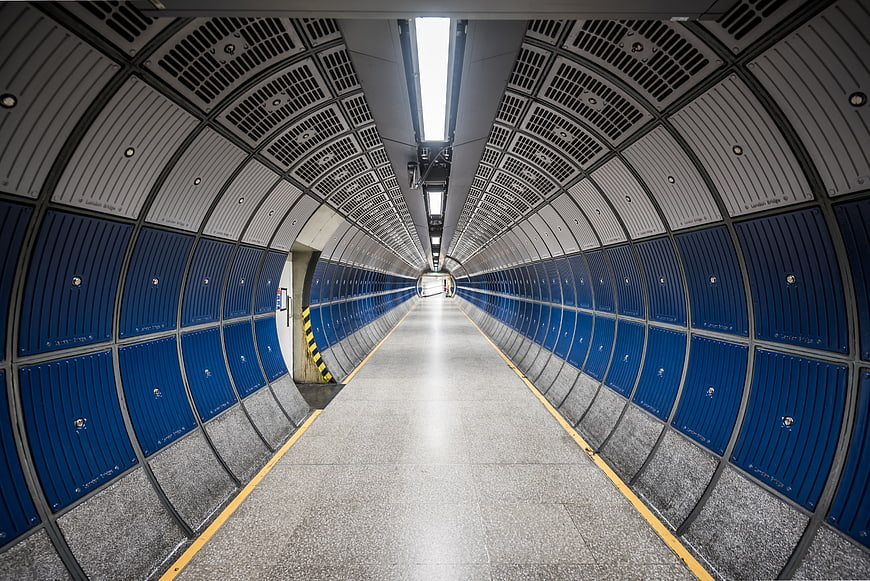 Symmetrical Blue and White Subway Tunnel Corridor