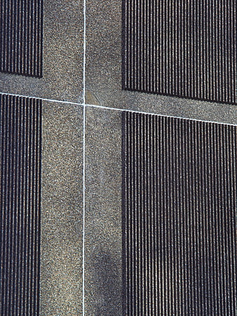 Abstract architectural facade texture with vertical lines and concrete