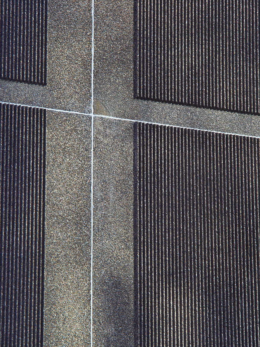 Abstract architectural facade texture with vertical lines and concrete