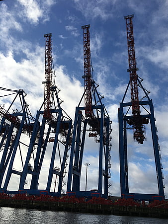 Blue and red container cranes at a shipping port