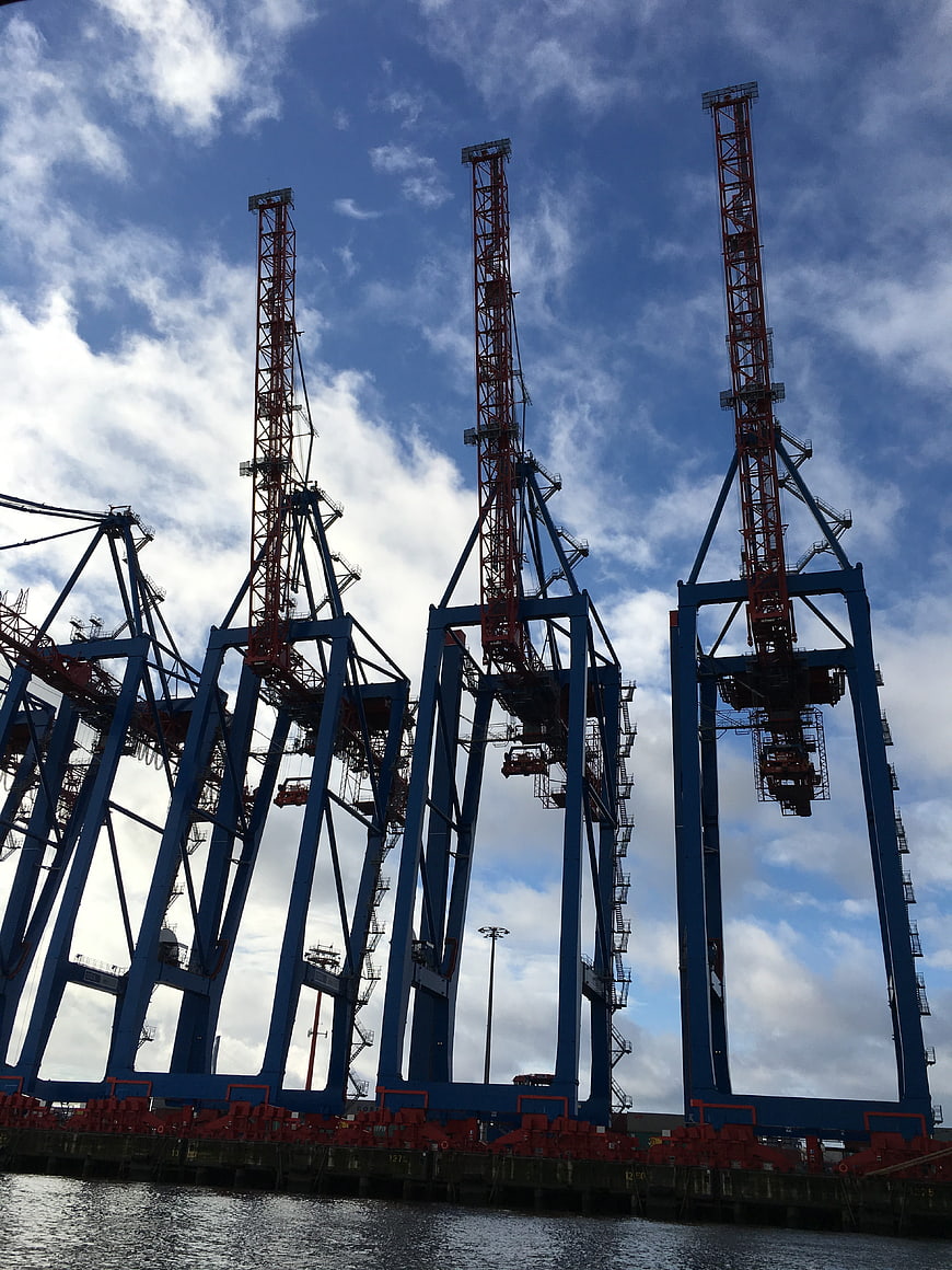 Blue and red container cranes at a shipping port