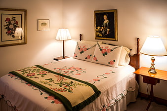 Cozy vintage bedroom with floral embroidered bedding and warm lighting