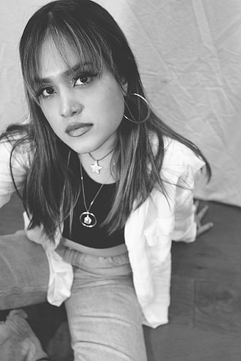 Black and white portrait of young woman with hoop earrings