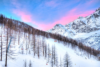 Snowy Mountain Ski Resort with Pink Sunset Sky