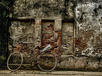 Vintage Bicycle Leaning Against Weathered Brick Wall