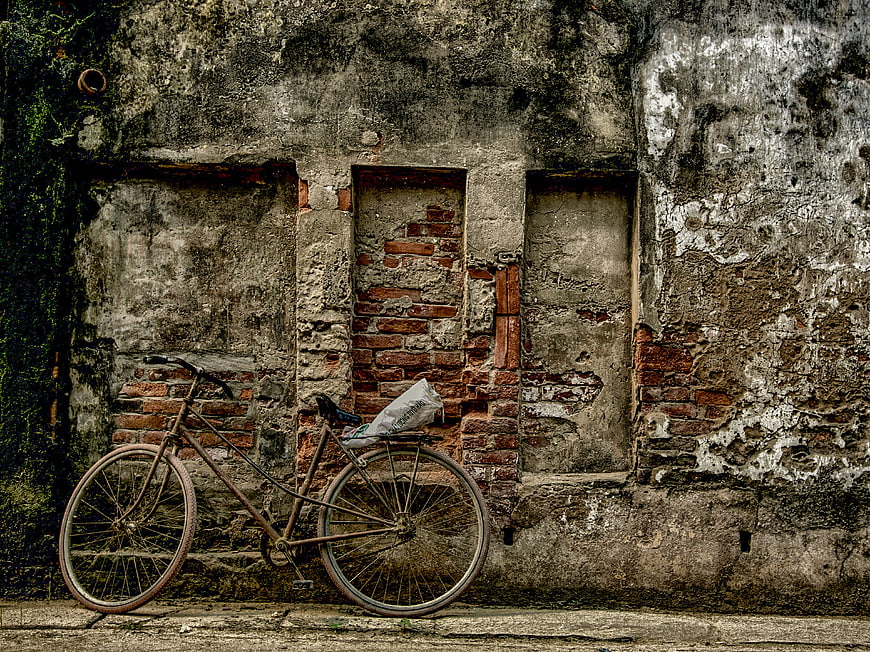 Vintage Bicycle Leaning Against Weathered Brick Wall