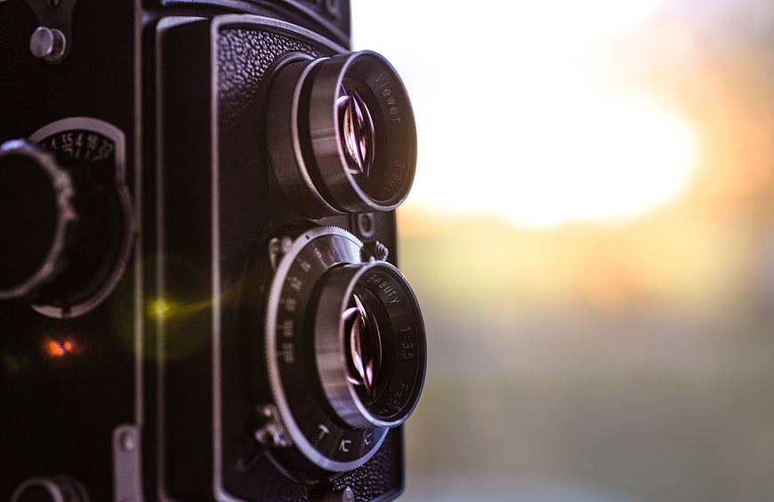 Vintage Twin Lens Reflex Camera Close-Up with Sunset Background