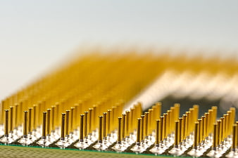 Macro shot of gold CPU pins on green circuit board