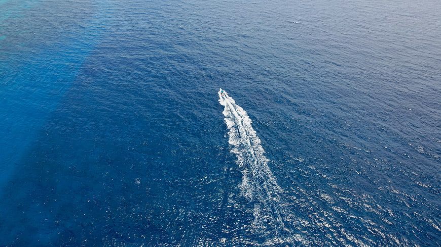 Aerial View of Speedboat Leaving White Wake on Blue Ocean