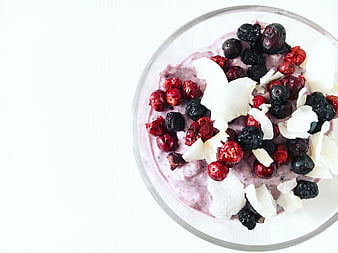 Top view of healthy berry smoothie bowl with coconut