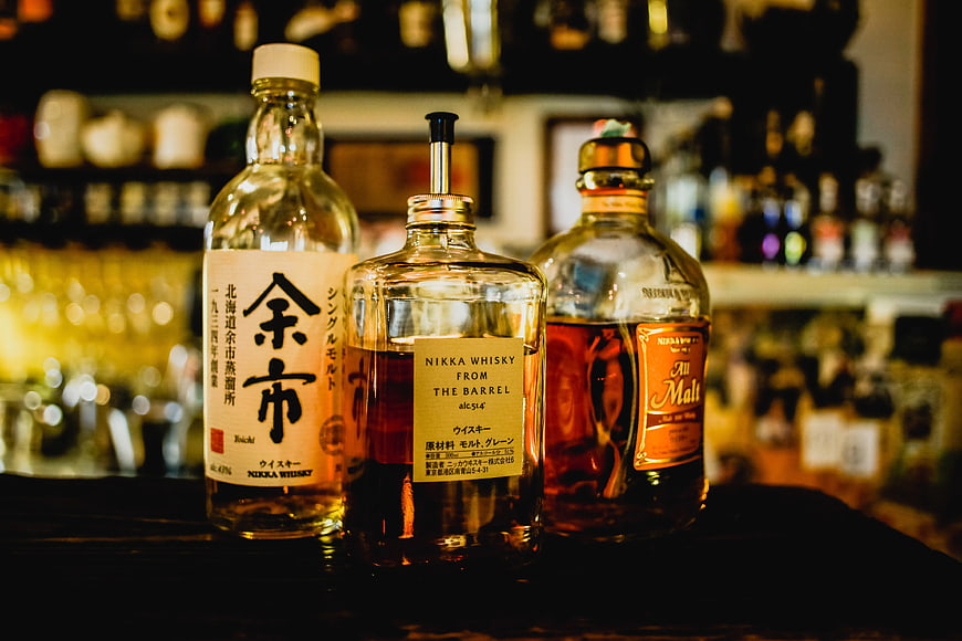 Three Japanese Whisky Bottles on Bar Counter