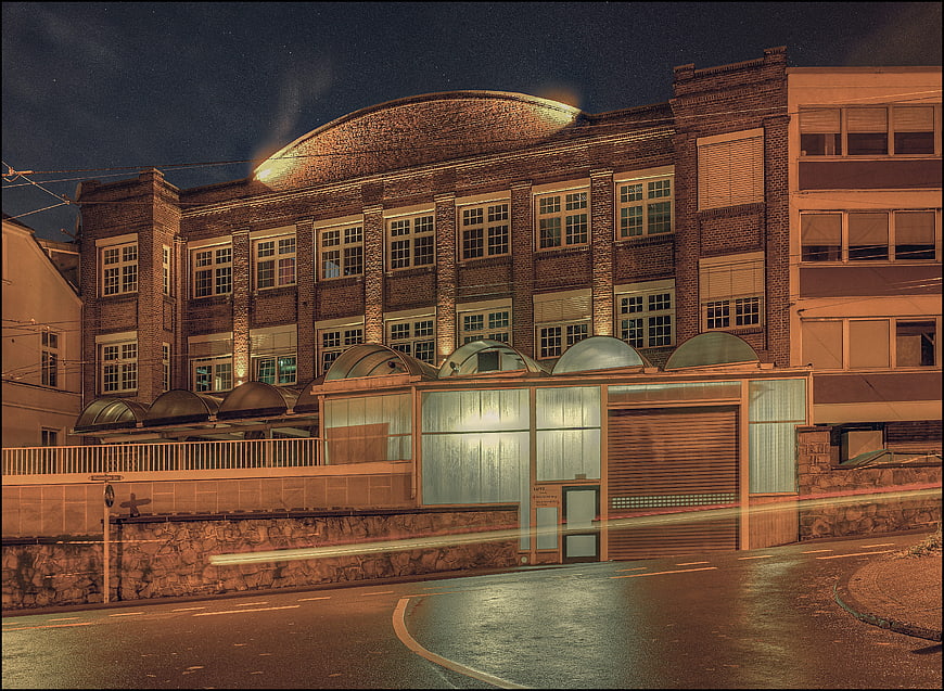 Night photography of historic brick factory building with light trails